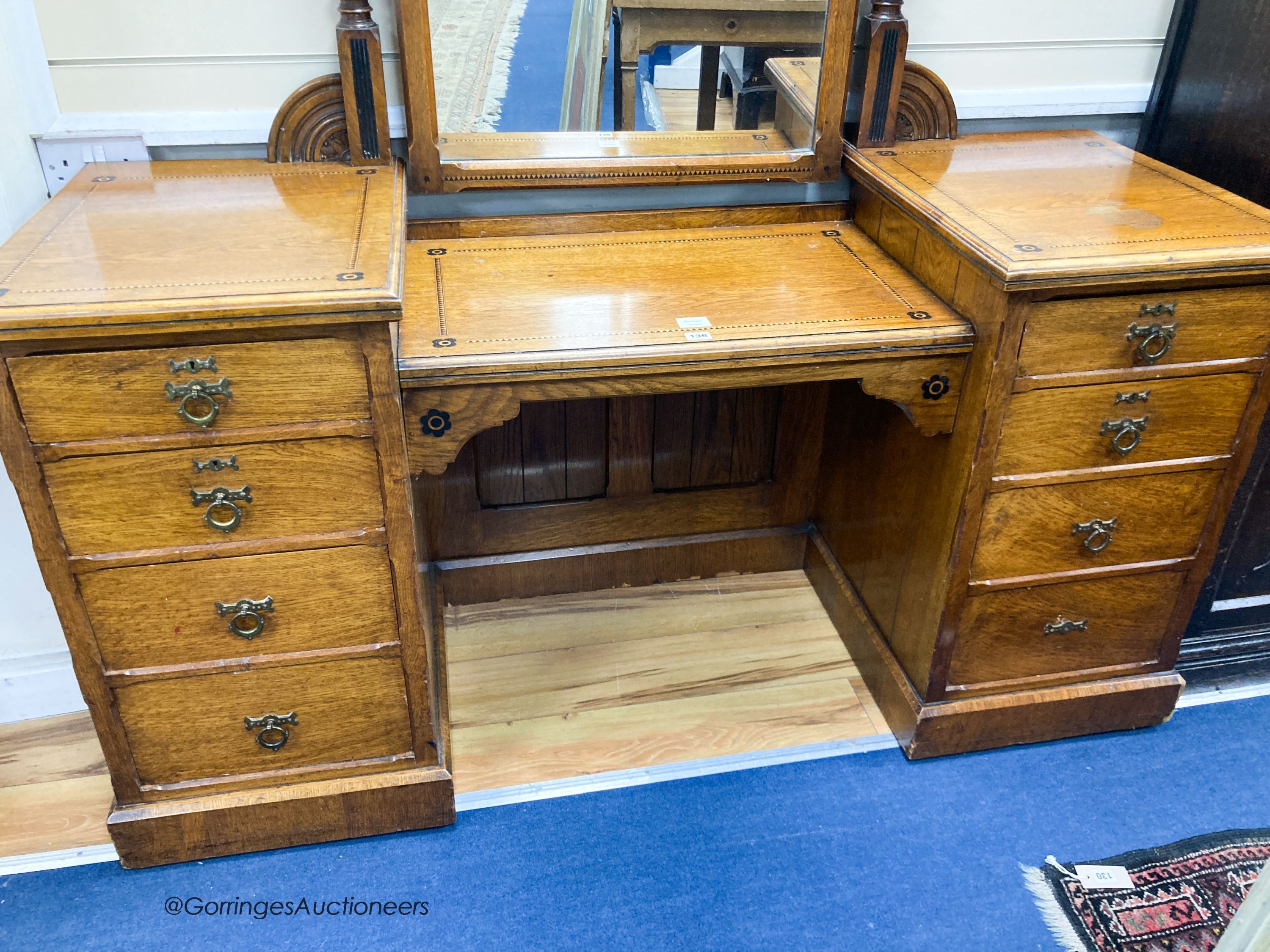 A late Victorian inlaid oak Aesthetic movement dressing table by Garnett & Son, Warrington, width 161cm, depth 59cm, height 176cm